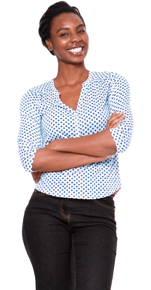 Woman standing in a blue top with arms folded.