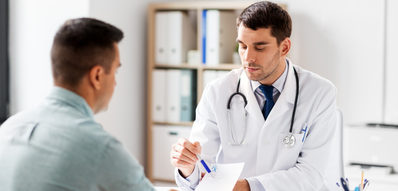 A doctor showing a patient a referral note.